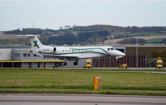 Alex Salmond's coffin arrives at Aberdeen Airport in a plane