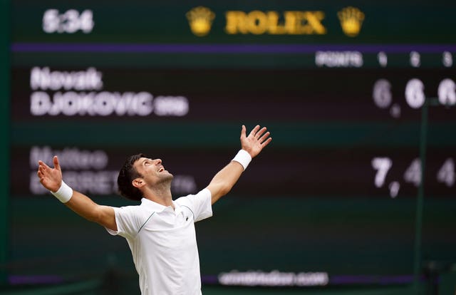 Novak Djokovic raises his arms and looks to the skies after winning another Wimbledon title