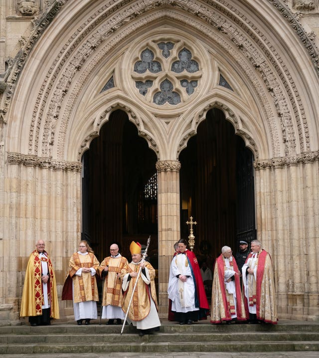 Members of the clergy standing outside York Minster 