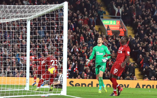 Xherdan Shaqiri, left, celebrates scoring the third goal as Liverpool's 4-0 win against Newcastle moves them six points clear at the top