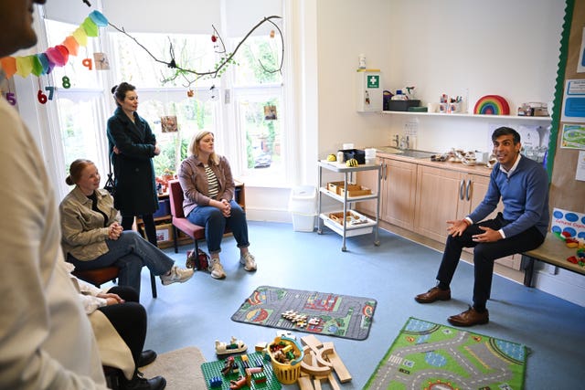 Rishi Sunak speaks to parents during his visit to the nursery