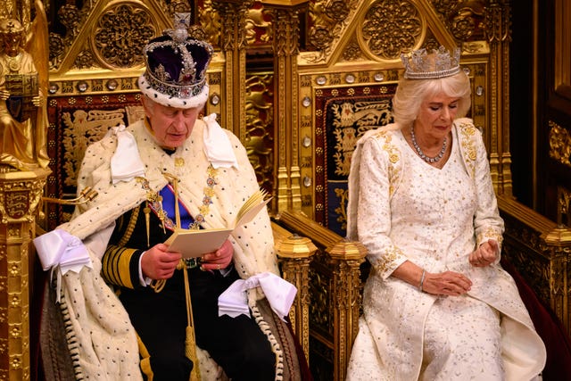The King delivers his speech beside the Queen during the State Opening of Parliament in the House of Lords 