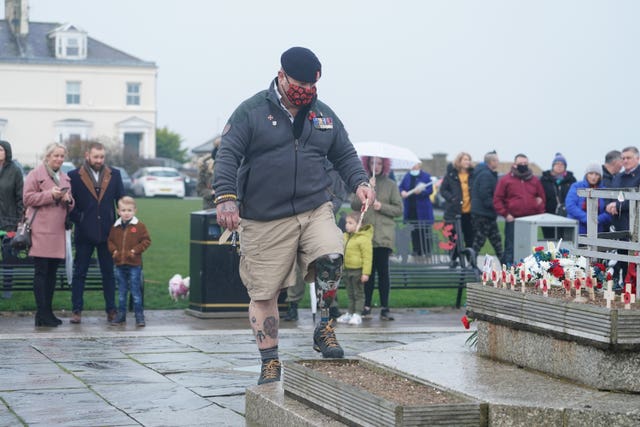 A veteran places a cross during the Seaham ceremony 