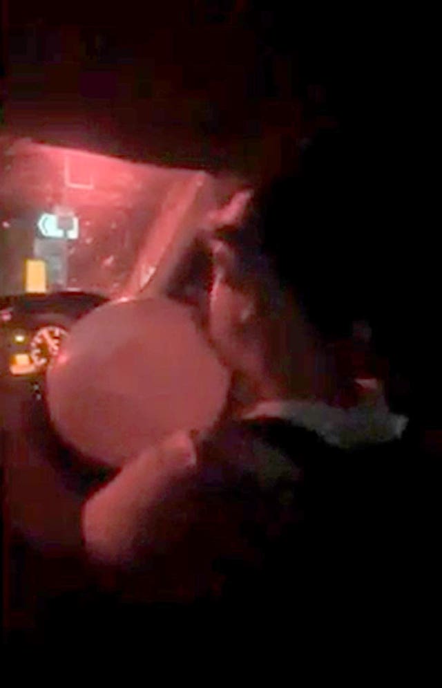 A screengrab of Thomas Johnson with a balloon in his mouth, inhaling nitrous oxide filmed before the crash 