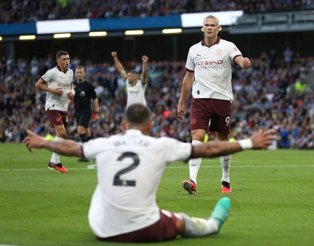 Erling Haaland, right, and Kyle Walker, seated, celebrate Haaland's second goal against Burnley