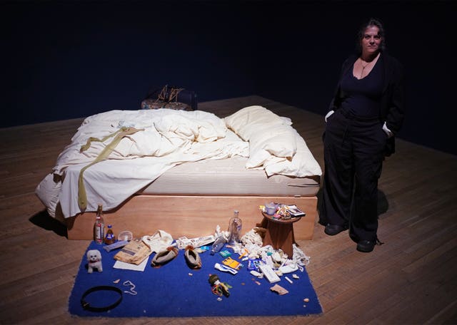 Dame Tracy Emin stands next to her artwork, My Bed, 1998, ahead of the new exhibition, Tracey Emin: A Second Life at London’s Tate Modern