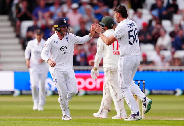 England’s Ollie Pope (left) celebrates with Josh Tongue after catching out Zimbabwe’s Craig Ervine