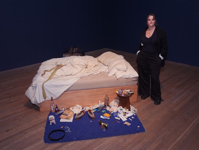 Dame Tracy Emin stands next to her artwork My Bed, 1998