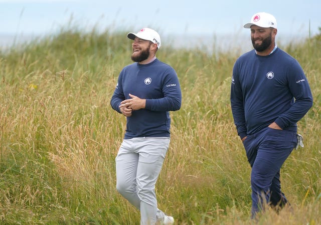 Tyrrell Hatton (left) and Jon Rahm leave the third tee during an Open practice round