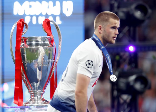 Eric Dier walks past the trophy with his runner-up medal