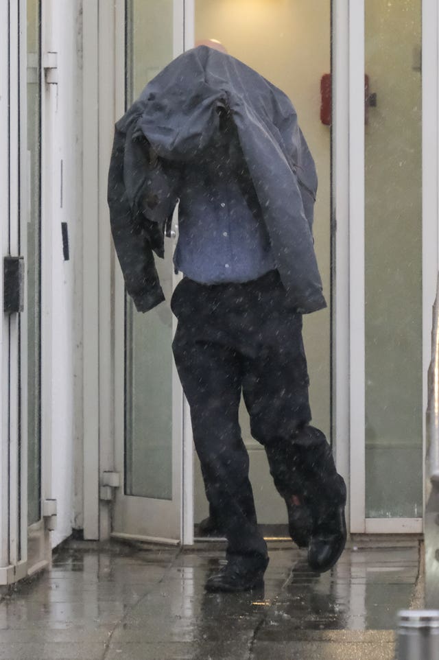 Timothy Schofield covered his head when leaving court (Matt Keeble/PA)