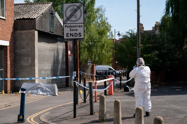 A forensic officer near the scene in Boston after a nine-year-old girl died from a suspected stab wound
