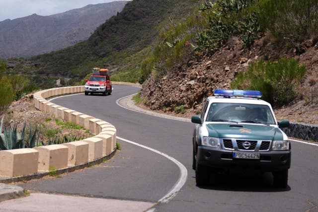 A search team car travels along a twisty road in Tenerife