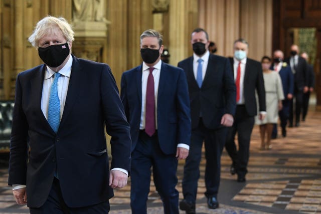 Prime Minister Boris Johnson (left) and Labour leader Sir Keir Starmer (second left) walk through the Central Lobby on the way to the House of Lords (Stefan Rousseau/PA)