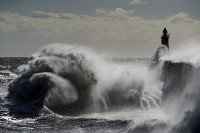 Waves crash against the Tynemouth Lighthouse on the North East coast