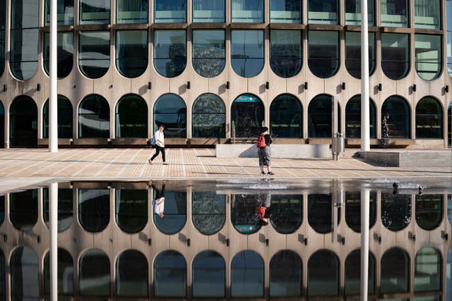 People walk by Centenary Square in Birmingham