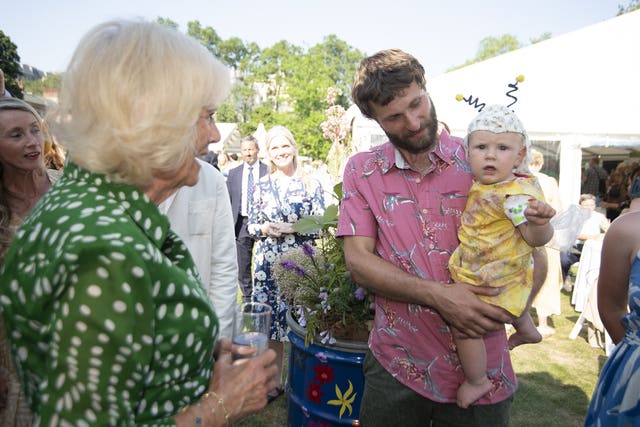 Camilla greets a baby