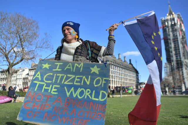 A woman takes part in the One Day Without Us rally in London