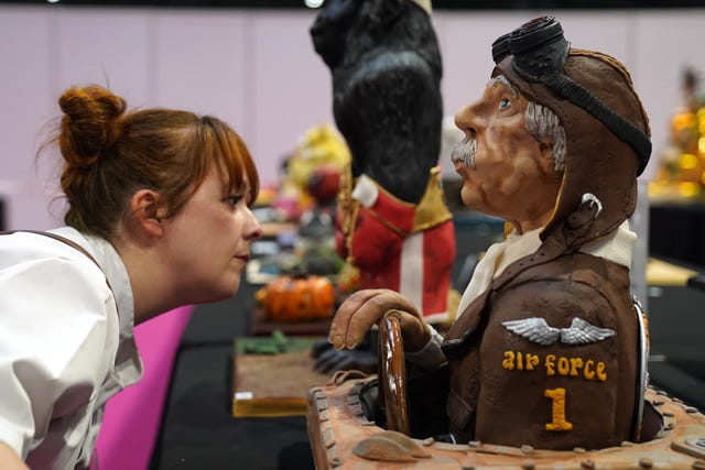 A judge examines a cake