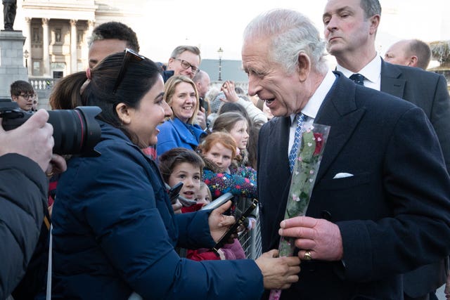 Charles receives a rose for Valentine's Day from a well wisher.