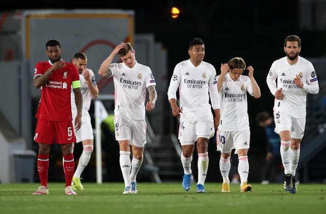Liverpool’s Georginio Wijnaldum (left) appears dejected as Real Madrid players celebrate a goal