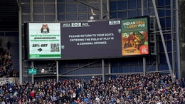 The stadium’s big screen displays a message asking for fans to return to their seats (Bradley Collyer/PA)