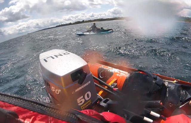 An RNLI crew helps rescue a kayaker