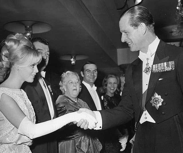 The Duke of Edinburgh shakes hands with Swedish actress Britt Ekland at the Royal Film Performance in London