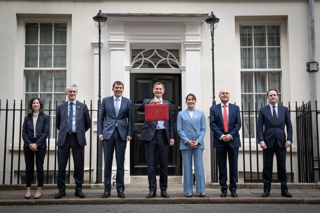 Chancellor Jeremy Hunt leaves 11 Downing Street with his ministerial box and members of his ministerial team before delivering his Budget in Parliament