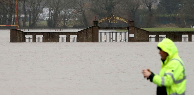 A man stops to take a picture of flood water at the Bishop Casey Memorial Park in Mallow, Co Cork, in the Republic of Ireland, where the River Blackwater has burst its banks. Picture date: Tuesday February 23, 2021 