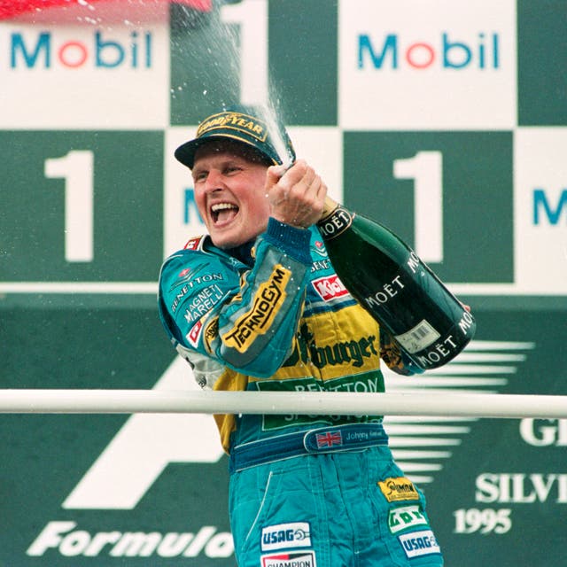 Britain's Johnny Herbert celebrates his first Grand Prix win in his 71st race. The Benetton-Renault driver took the chequered flag ahead of Frenchman Jean Alesi and compatriot David Coulthard
