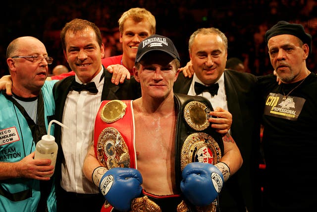 Ricky Hatton holds titles over each shoulder