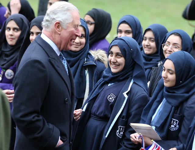 Charles is greeted by local schoolchildren