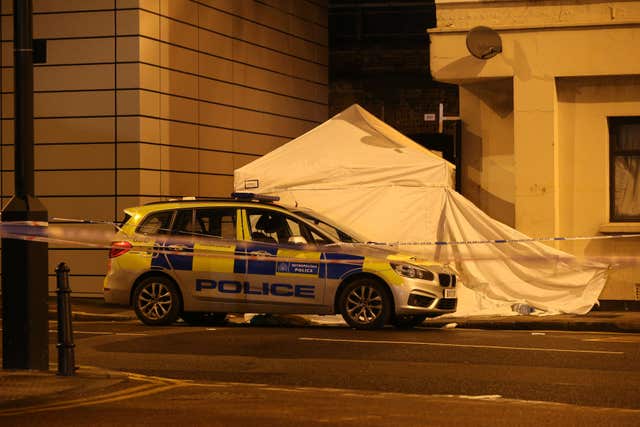 Police at the scene (Jonathan Brady/PA)