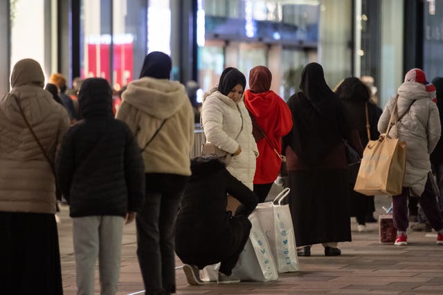 Shoppers queue outside Next in Leicester (Joe Giddens/PA)