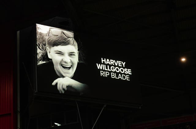 A tribute to Harvey Willgoose is shown on screens at the stadium