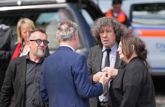 Actor Stephen Rea (second right) at Mountshannon ahead of the burial