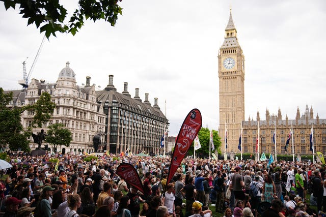 A crowd of thousands with the Houses of Parliament in the background