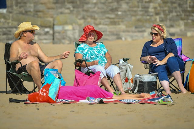 People enjoy the sun at Barry Island