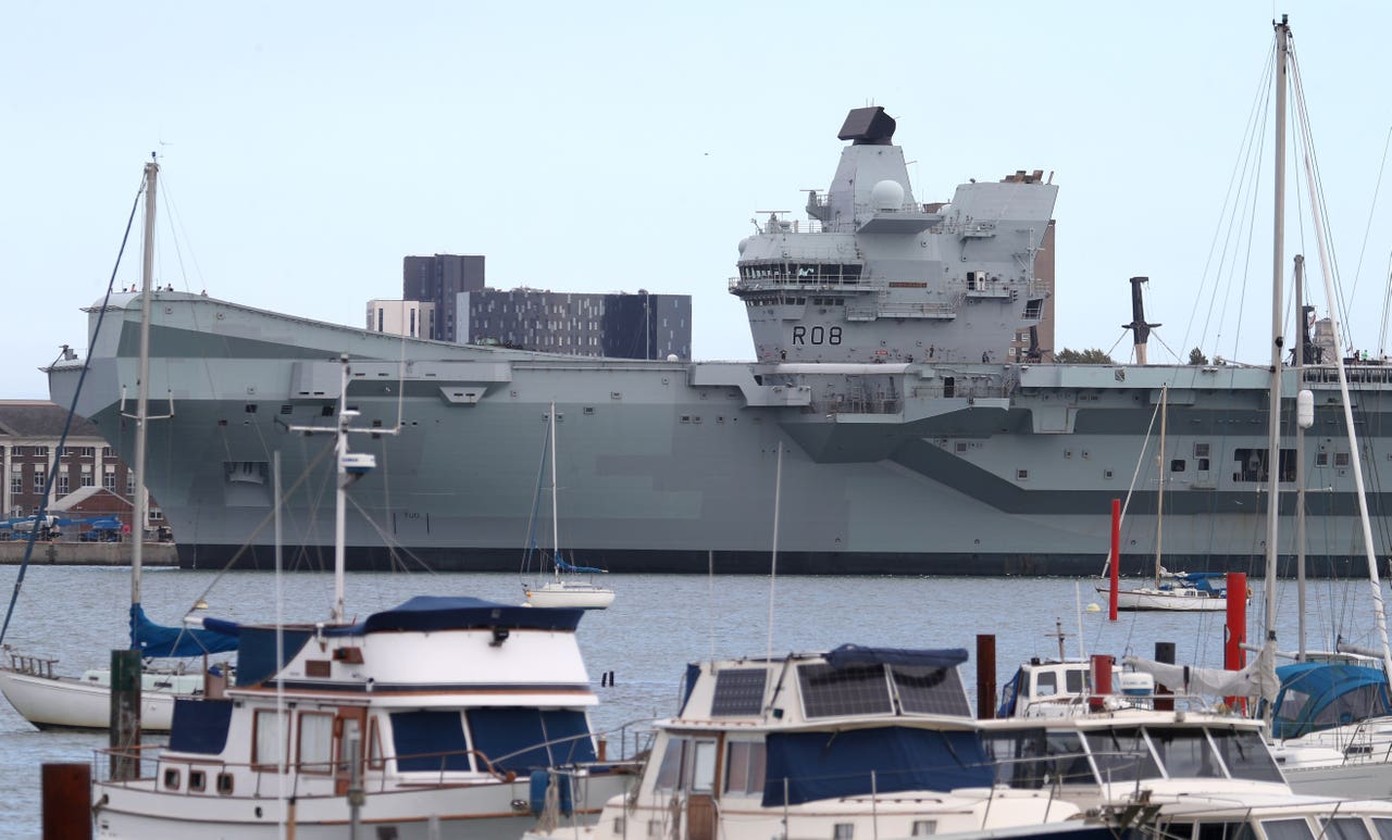 Aircraft carrier sets sail after two-day delay caused by Covid-19 ...