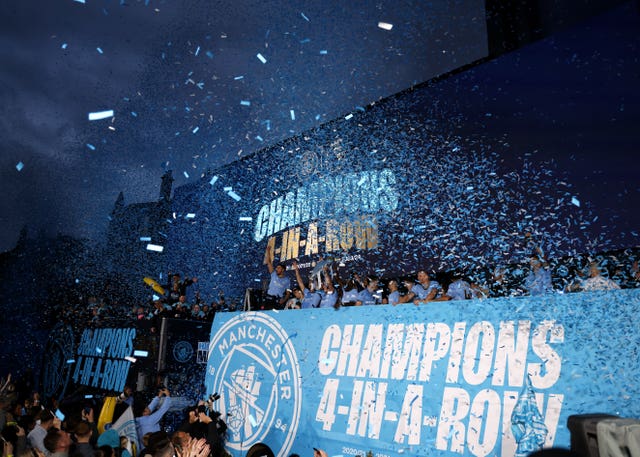 Manchester City players celebrating their title success with a parade