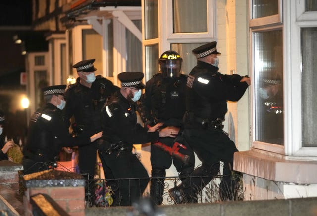Merseyside Police make an early morning raid on a home in Liverpool, watched by Prime Minister Boris Johnson