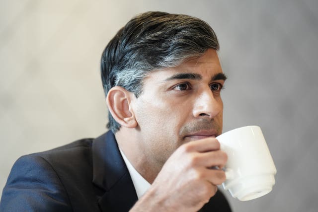 Rishi Sunak drinking from a cup