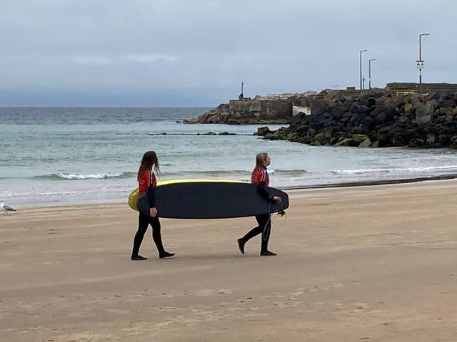 Visitors continued to come to the seaside town of Portrush on Northern Ireland’s north coast on Tuesday despite rain showers bringing the heatwave to an abrupt end 