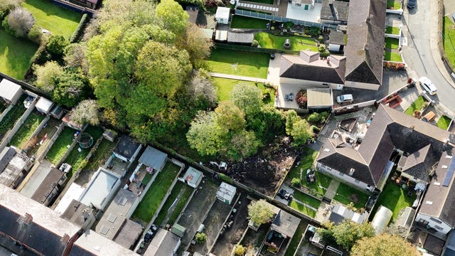 Gardai forensic officers searching waste ground seen from above