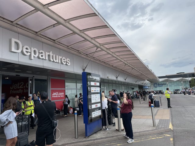 Passengers waiting outside the Departure gate at Birmingham Airport