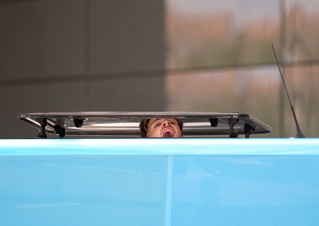 Jack Grealish pokes his head out of the skylight as City's coach leaves the team hotel in Istanbul