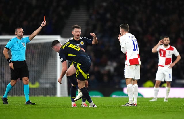 Croatia’s Petar Sucic, second right, reacts after being shown a red card against Scotland