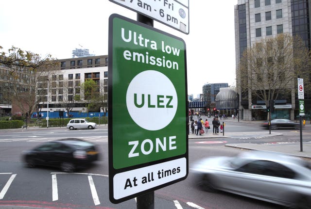 An ultra low emission zone sign on a busy road