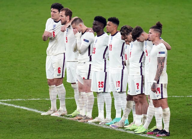 England’s Jadon Sancho  and Bukayo Saka stand alongside their team-mates during the penalty shoot-out